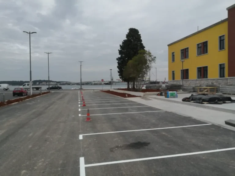 Svježe iscrtane bijele linije za parkirna mjesta na novom asfaltu u luci Sv. Katarina