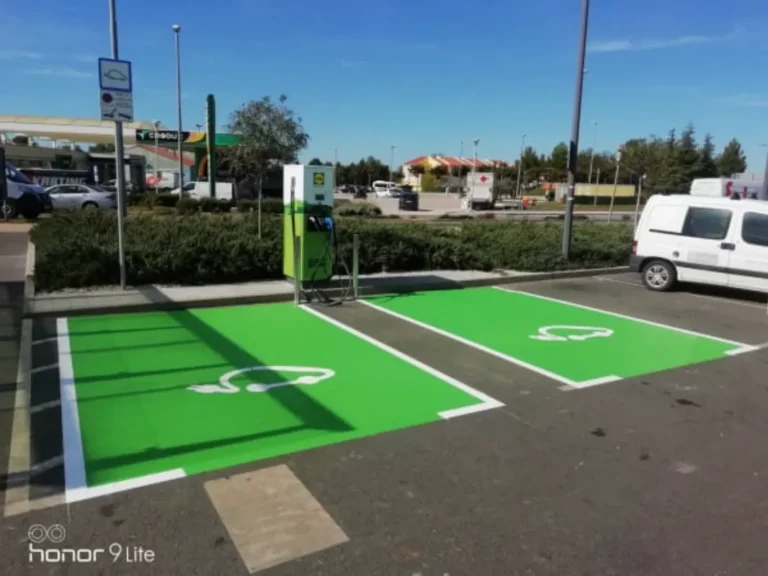 Jasno označena zelena parkirna mjesta za električne automobile ispred trgovačkog centra.