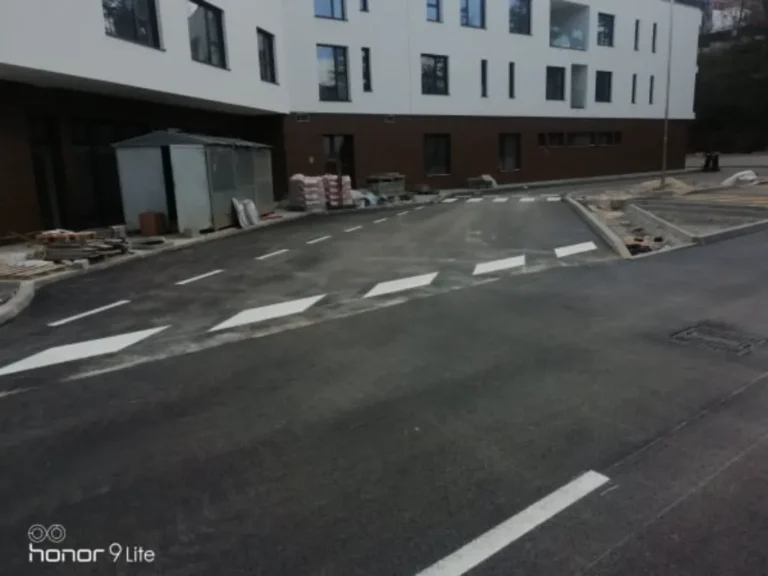 Horizontalne oznake i prometni otoci za usmjeravanje prometa na prilaznoj cesti.
