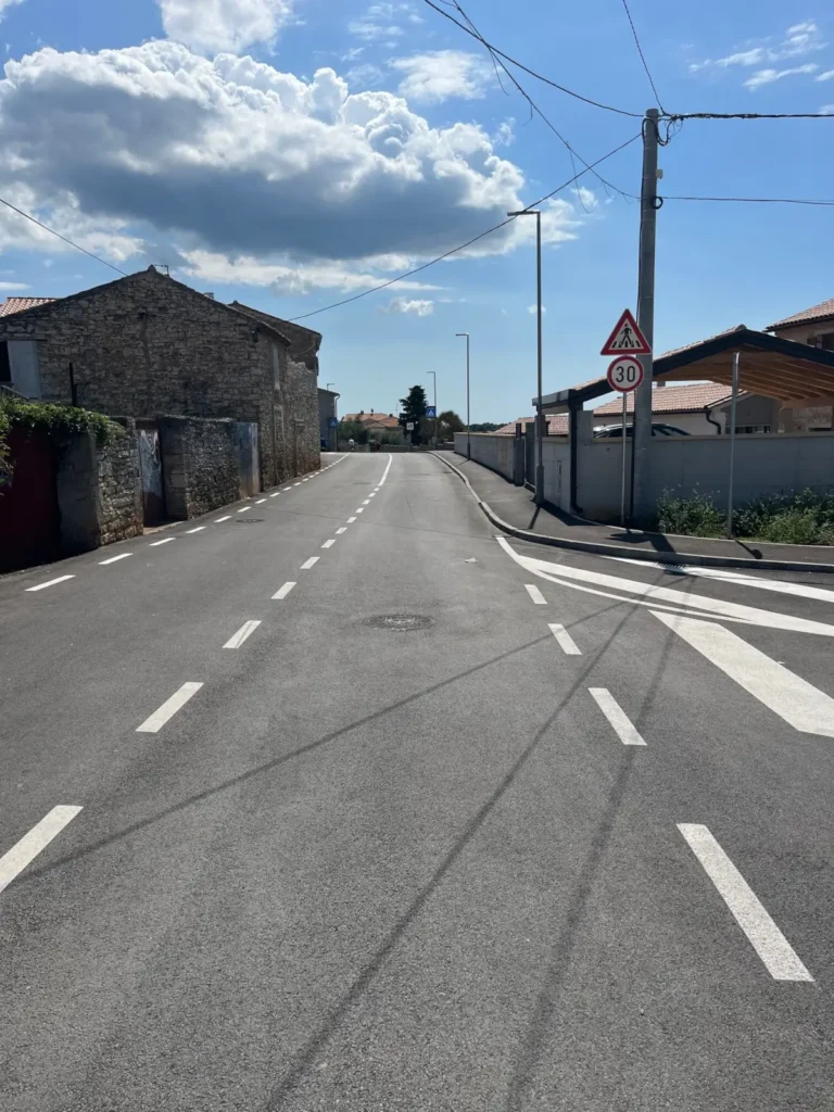 Nova horizontalna signalizacija sa središnjim isprekidanim linijama na obnovljenoj prometnici.