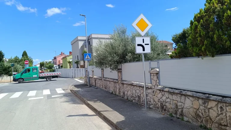 Prometni znak za cestu s prednošću prolaska na raskrižju u Medulinu uz radno vozilo tvrtke LIČILAC